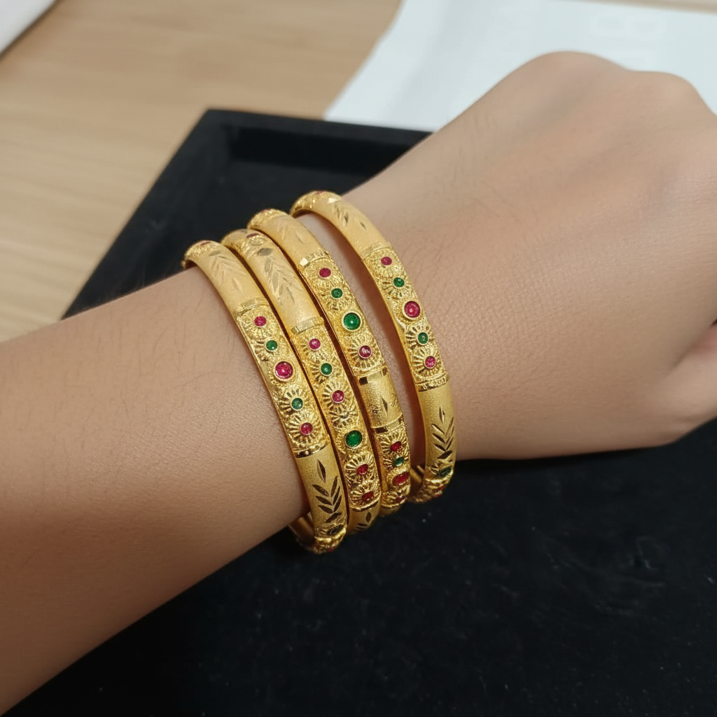 Four Gold-Colored Bangles