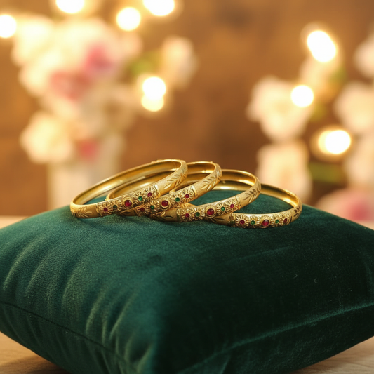 Four Gold-Colored Bangles